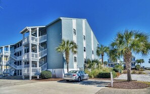 A multi-story building with balconies and a parking area. - Oceanview Paradise: Relaxing 2-Bedroom Condo in Surfside Beach (Surfside Beach)