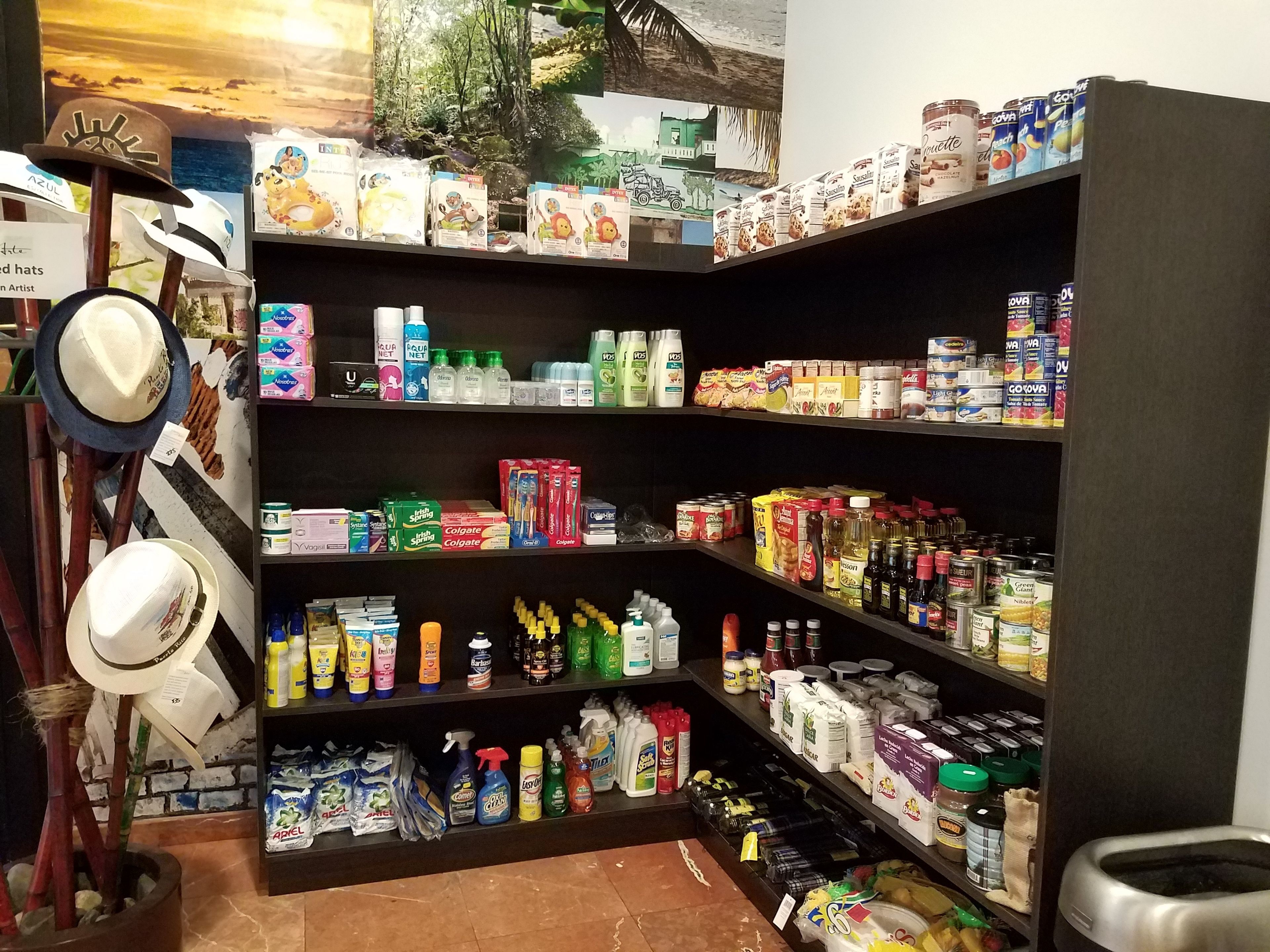 A well-stocked grocery shelf with various products including snacks, beverages, and household items.