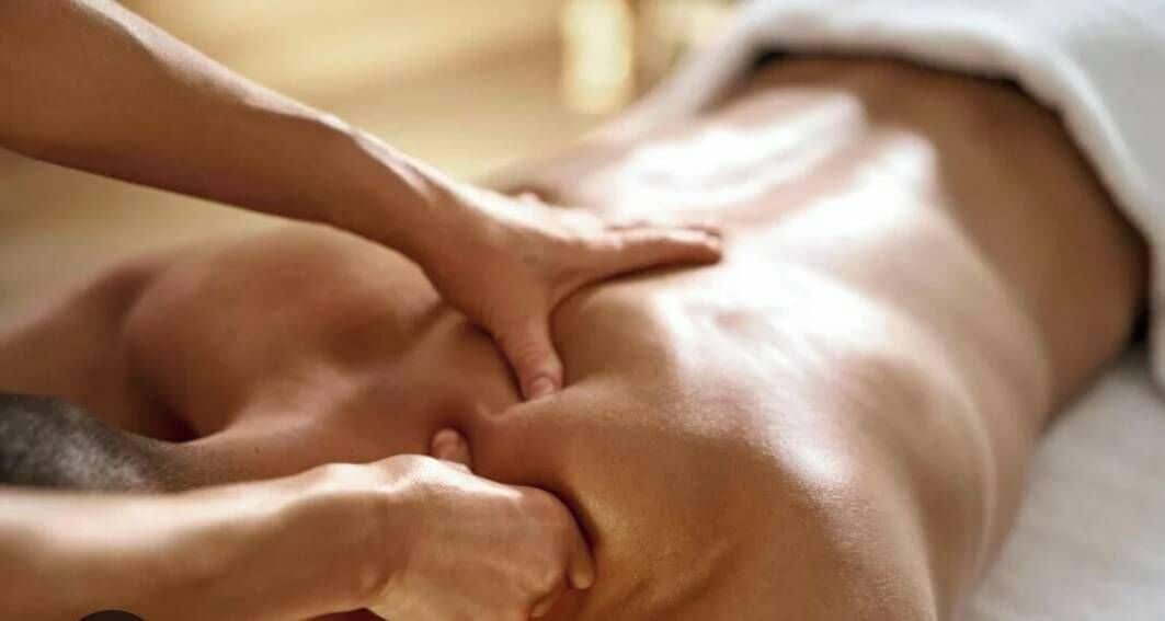 A close-up of a massage being performed on a person's back.