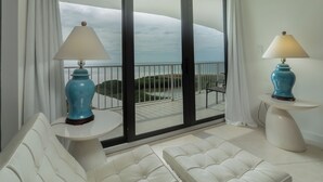 A balcony with a view of the sea, a white sofa, and two lamps. - Spectacular Gulf views- South Seas Tower 4-1607 (Marco Island)