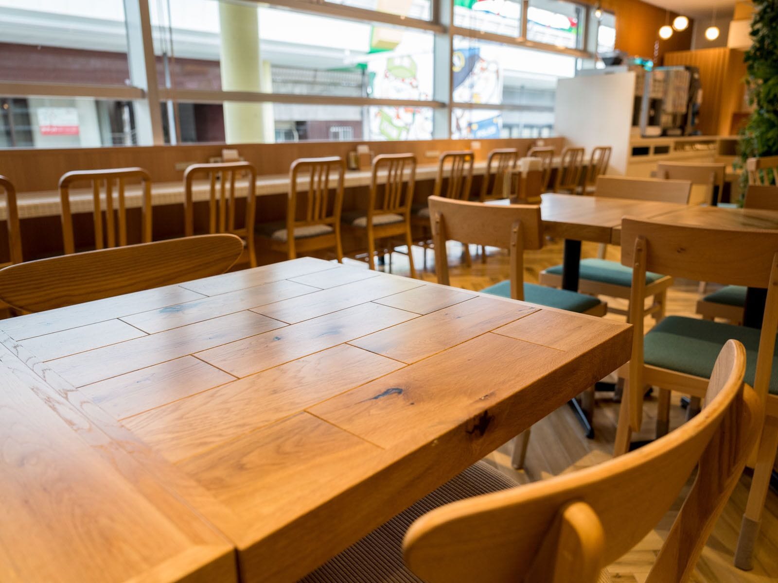 A wooden table with chairs in a cafe setting.