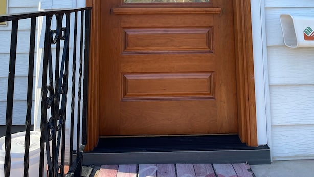 A wooden front door with a glass panel, a wreath, and a mailbox. - Prairie Cottages in historic Rapid City (Rapid City)