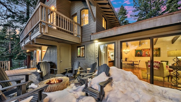 A multi-level wooden house with a deck, outdoor seating, and a fire pit. - New! Majestic Mountain Retreat (Incline Village)