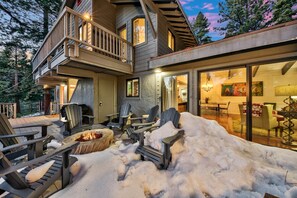 A multi-level wooden house with a deck, outdoor seating, and a fire pit. - New! Majestic Mountain Retreat (Incline Village)