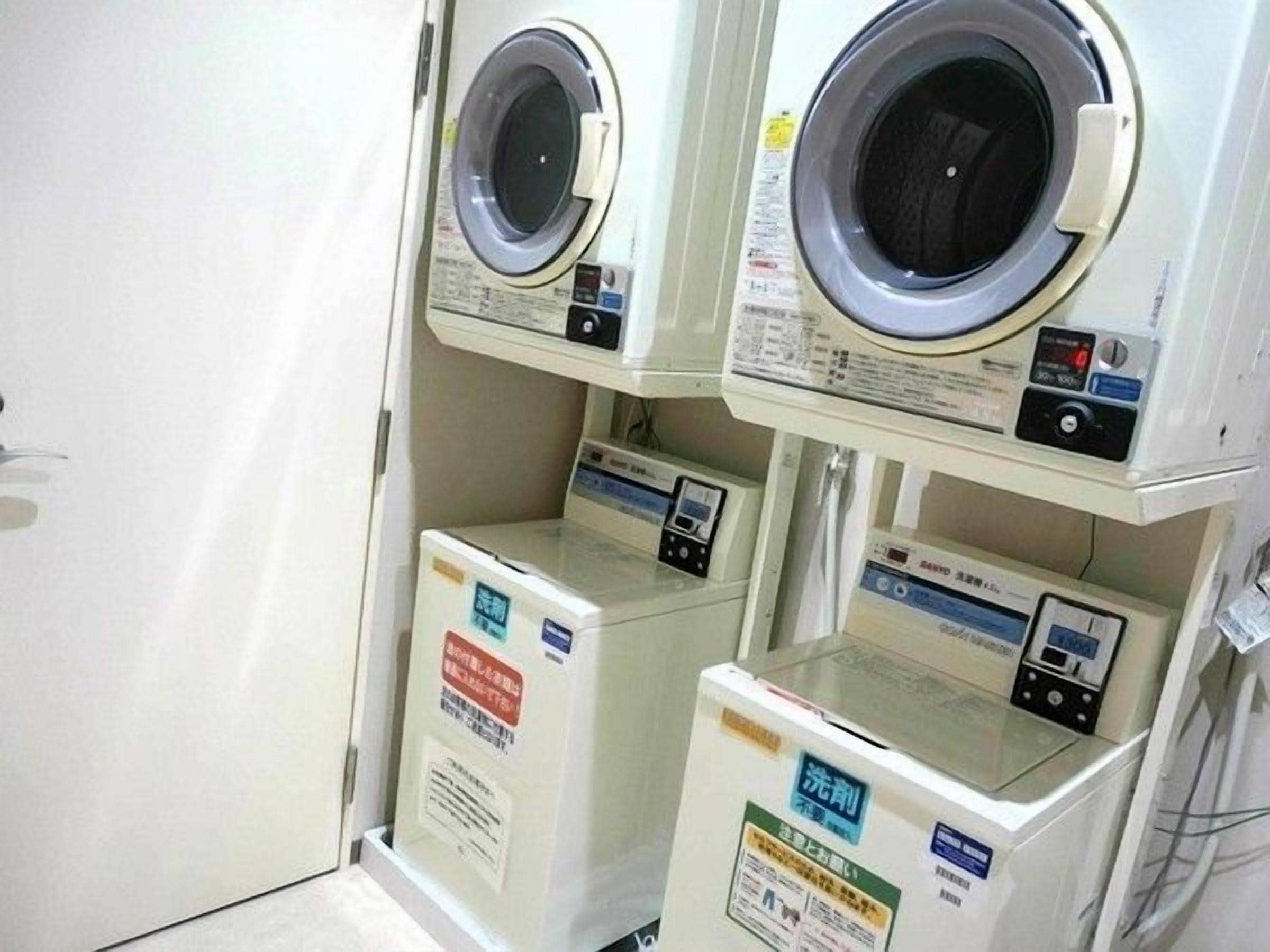 A laundry facility with multiple washing machines and dryers.