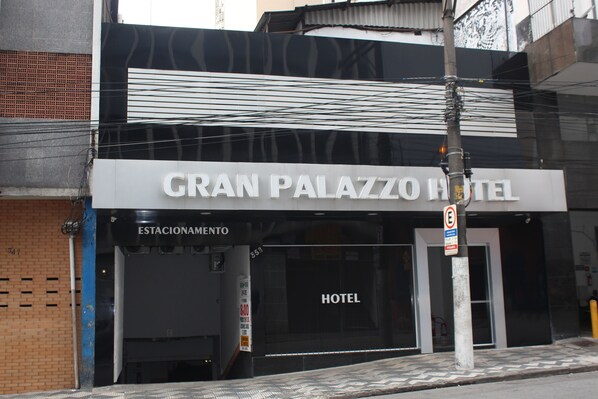 The exterior of Gran Palazzo Hotel with a sign indicating it is a hotel.