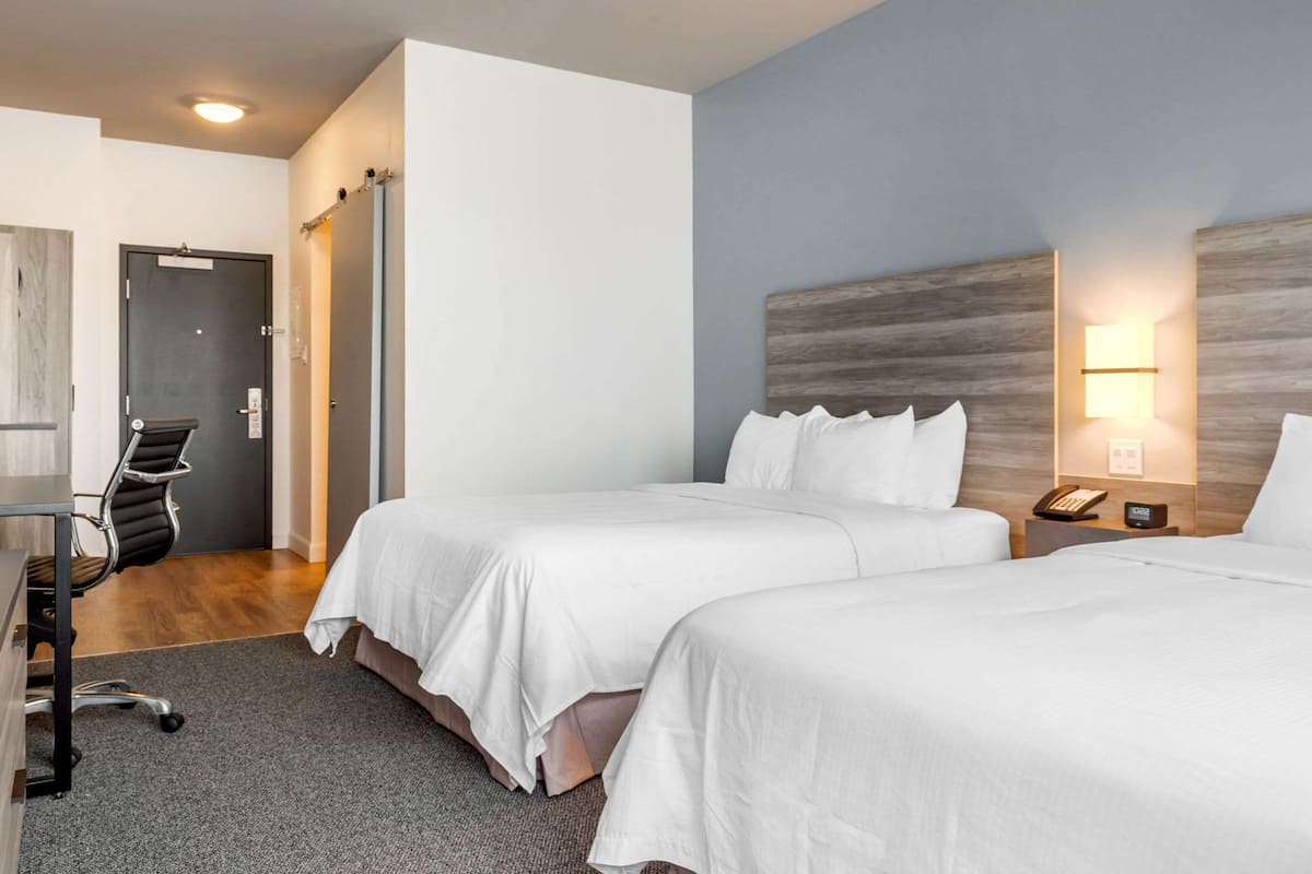 Standard Room, 2 Queen Beds, Non Smoking | In-room safe, desk, soundproofing, free WiFi