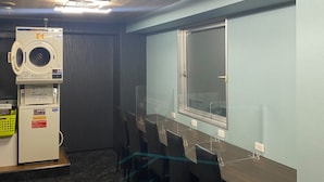 Una sala conferenze con un grande tavolo, sedie, una finestra e un soffitto con illuminazione a incasso.