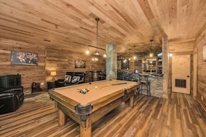 A wooden interior with a pool table, bar area, and seating. - 5 Acres to Roam | Stocked Game Room + Wet Bar  | Our Place to Paws (Lansing)