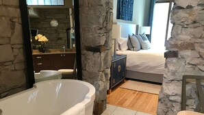 A bathroom with a freestanding bathtub, a mirror, a sink, and a vanity. - Downtown MainStreet Penthouse 1BR five star Rental with parking overlooking main (Durango)
