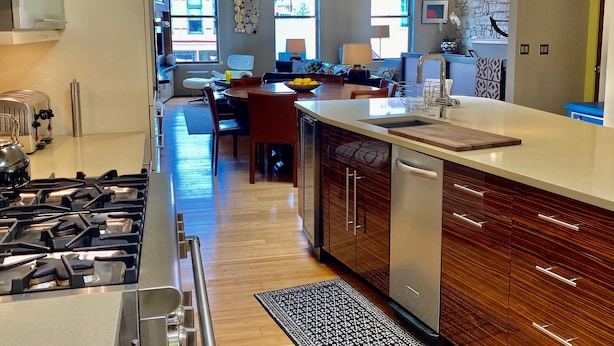 A modern kitchen with a central island, stainless steel appliances, and a dining area with a view. - Downtown MainStreet Penthouse 1BR five star Rental with parking overlooking main (Durango)