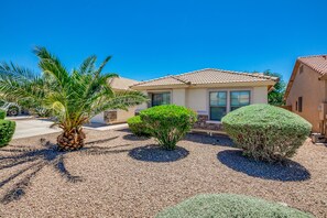 Surrounded by a beautifully landscaped garden, this single-story house offers a serene retreat.