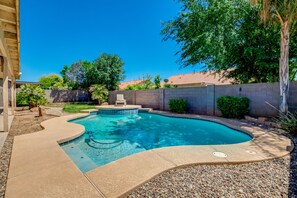Enjoy a serene escape in our beautifully landscaped backyard with a swimming pool and comfortable seating area.