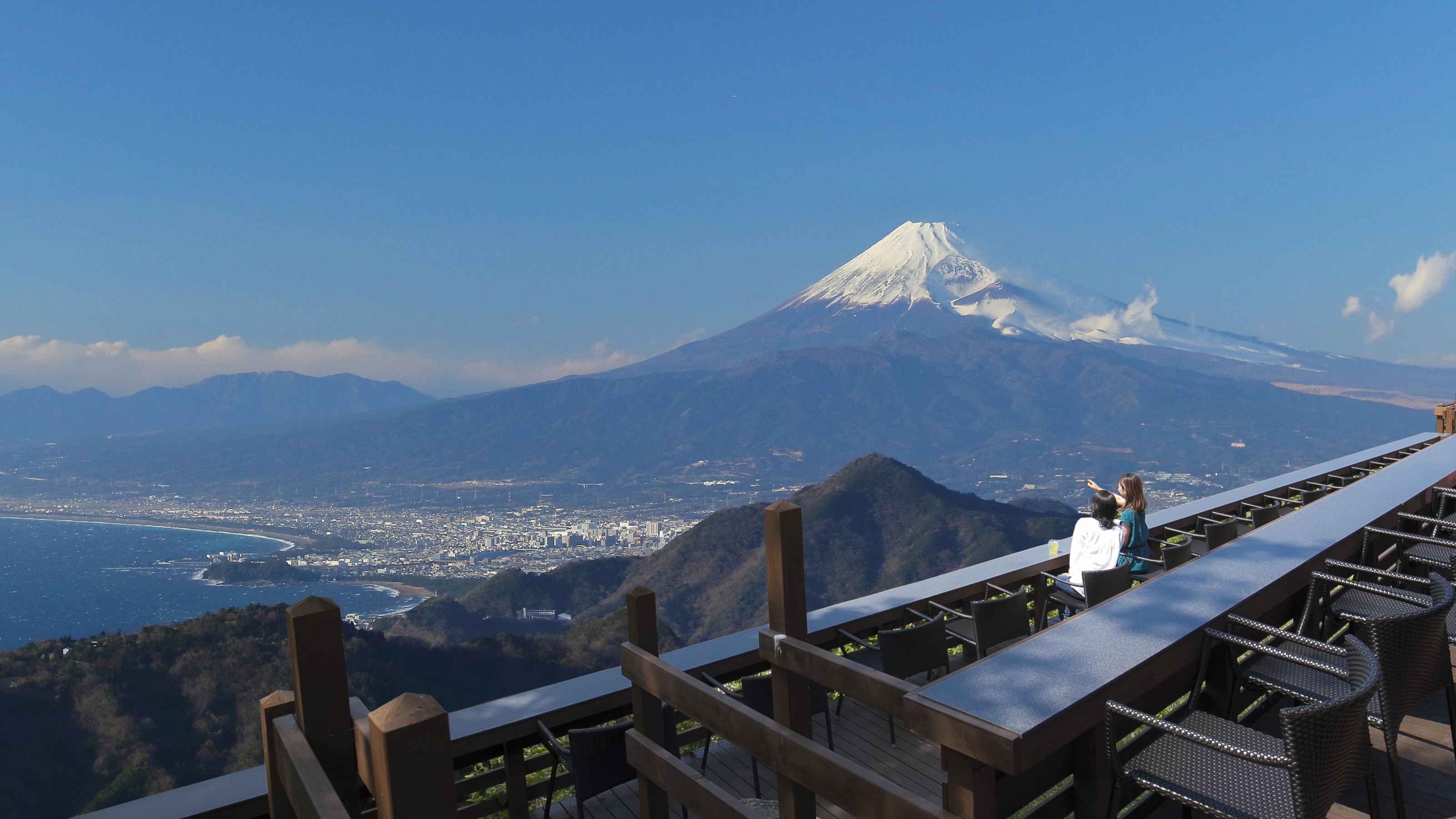 A high vantage point overlooking a city with a prominent mountain in the background.
