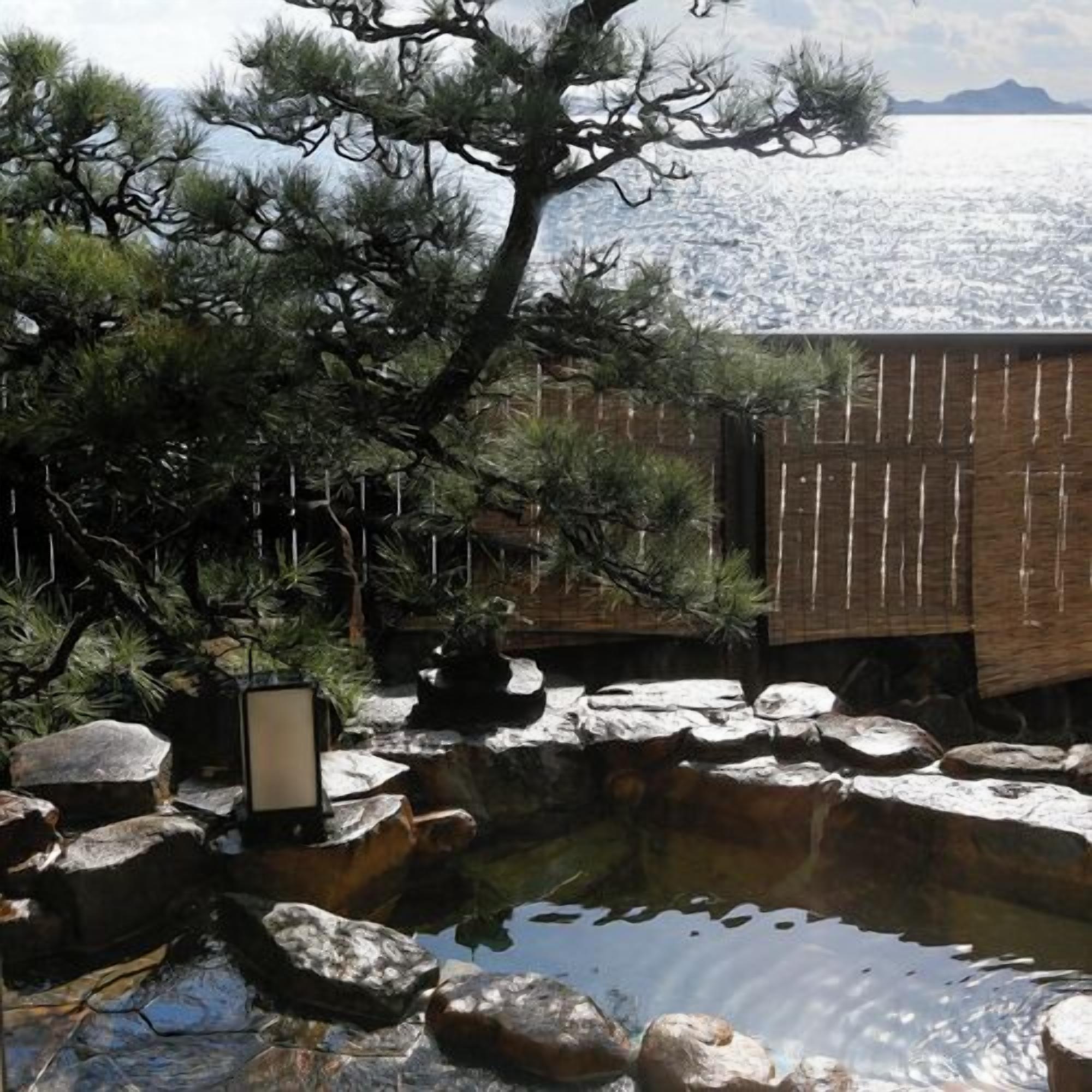 A traditional Japanese garden with a koi pond, rocks, and a pine tree.