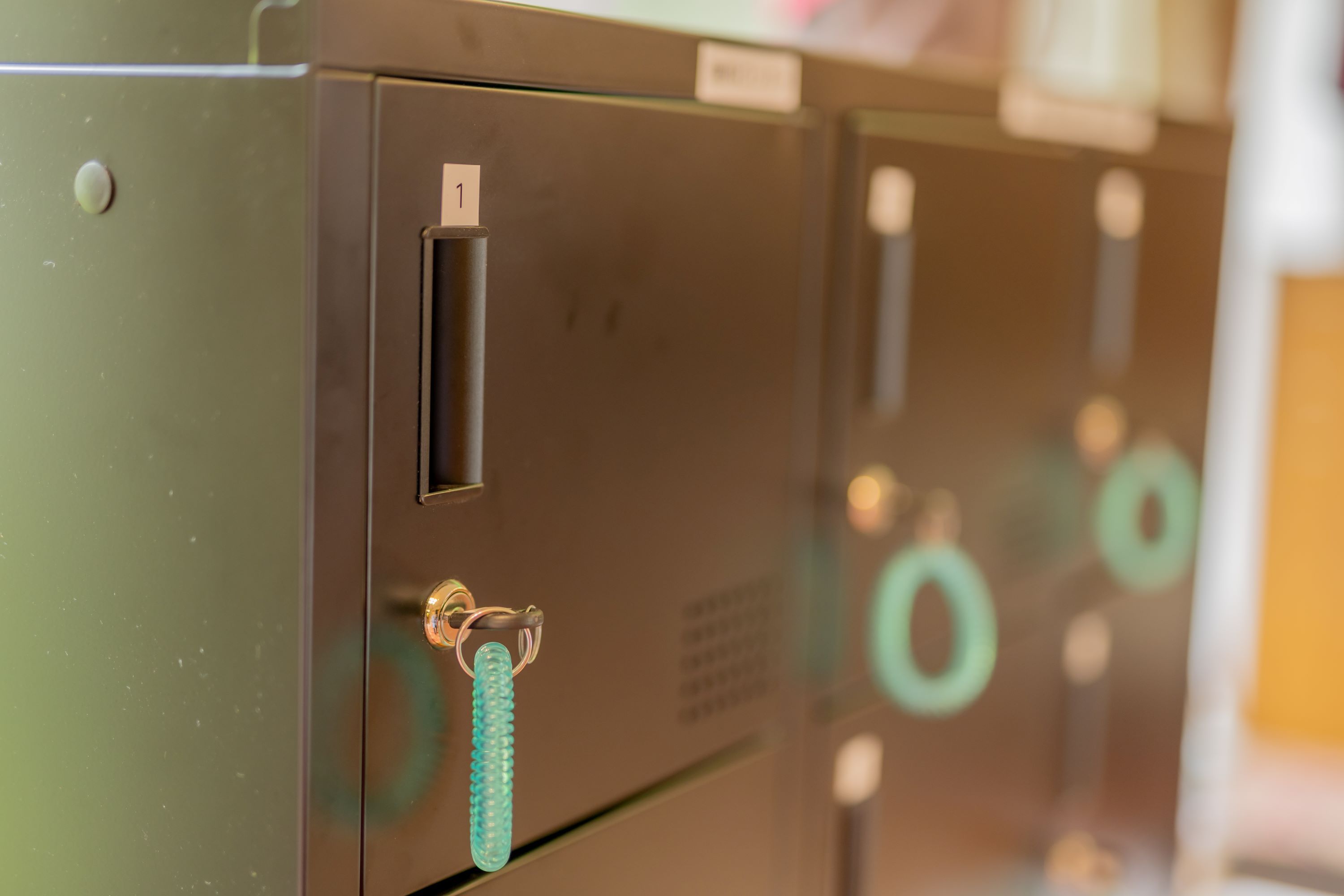 A row of filing cabinets with metal handles and a key slot.