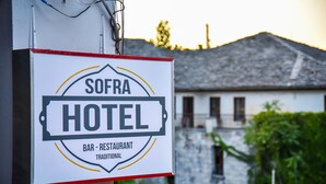 A sign for the Sofra Hotel, indicating it is a bar and restaurant with traditional offerings. - Hotel Sofra (Gjirokastër)