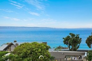 A coastal view with a building labeled 'Lorne Beach Pavilion' and a clear blue sky.