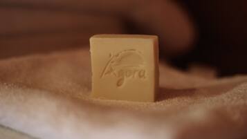 A small, square-shaped object with embossed text on a soft, textured surface.