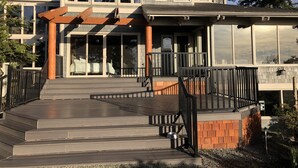 A modern house with a large front porch, a covered entryway, and a satellite dish. - The Alpaca Retreat - Luxury farm house with water view! (Camano Island)