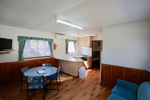 Lucas Cabin | Living area | Flat-screen TV - Jenolan Holiday Park - Campsite (Oberon)