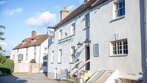 A white building with a sign reading "Black Horse" and a "No Parking" sign. - Black Horse (Arundel)