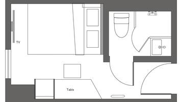 Een plattegrond van een hotelkamer met een televisie, een tafel en een badkamer.