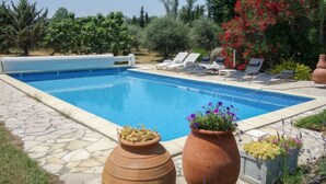 A swimming pool with lounge chairs and potted plants. - Mas Troumpill by Interhome (Argelès sur Mer)