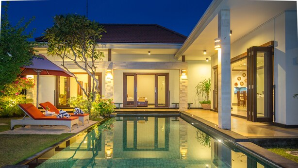 A modern house with a swimming pool, outdoor seating, and a well-lit entrance. - Villa Katara (Seminyak)