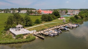 A lakeside dock with boats, a gazebo, and a walking path. - 36 Old Mill Way, Bayside at Bethany Lakes - 4 Bedroom Luxury w/Community Pool (Ocean View)