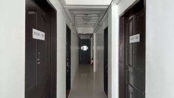 A corridor with doors labeled "ROOM - 303" and "ROOM - 304" in a hotel.