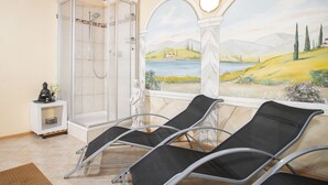 A spa room with a glass-enclosed shower, a statue, and a mural of a landscape. - Ferienhof Sonnseitn by Interhome (Kaltenbach)