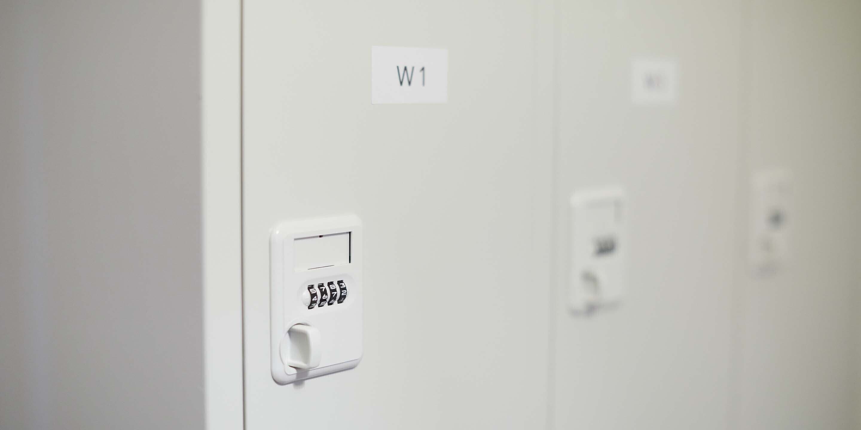 A white wall with a digital lock and a label reading "W1".
