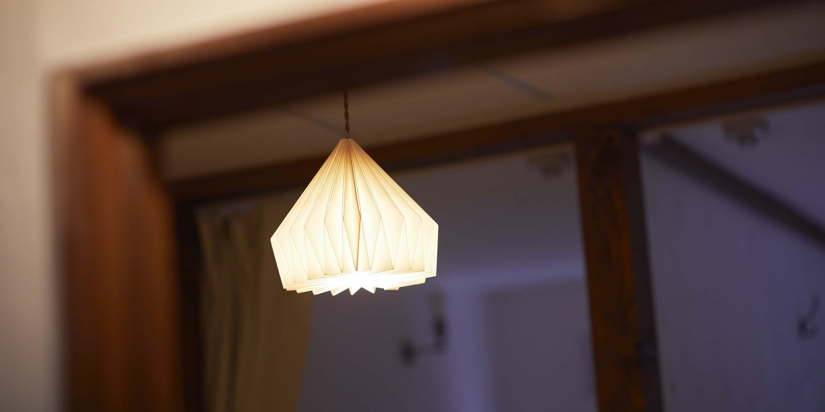 A hanging light fixture with a geometric design.