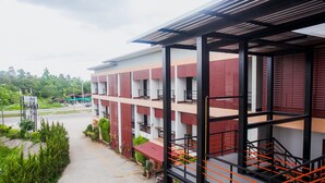 A multi-story building with balconies, a covered outdoor area, and a staircase. - The Areaac (Hang Chat)