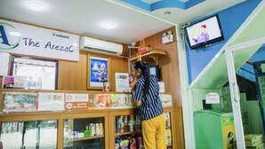 A store interior with a sign reading "The Areaac," shelves stocked with snacks, and a television on the wall. - The Areaac (Hang Chat)