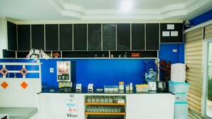 A kitchen area with a coffee machine, tea kettle, and various kitchen utensils. - The Areaac (Hang Chat)