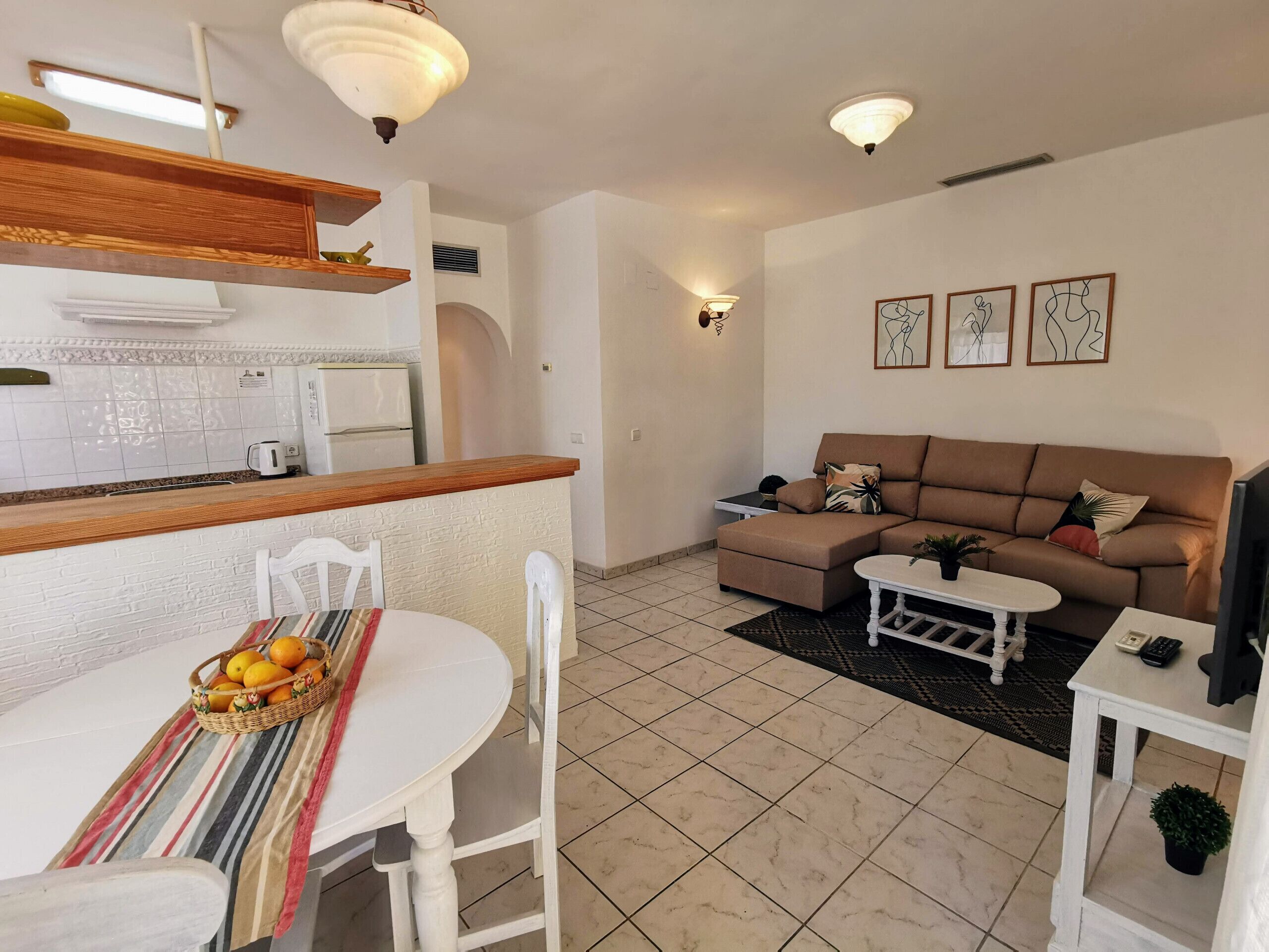 A compact living space with a kitchen, dining area, and seating area.
