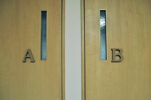 Two wooden doors with letters A and B, each with a small window. - Guest house HiDE (Toyako)