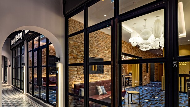 The Macalis Hotel entrance with a brick wall interior and a patterned floor. - Macalister Hotel Managed By The Ascott Limited (George Town)