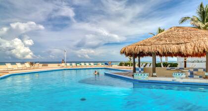 Charming waterfront apartment with private beach access, covered patio & pool