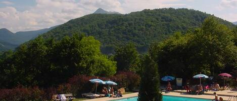 Seasonal outdoor pool, open 9:00 AM to 7:00 PM, pool umbrellas