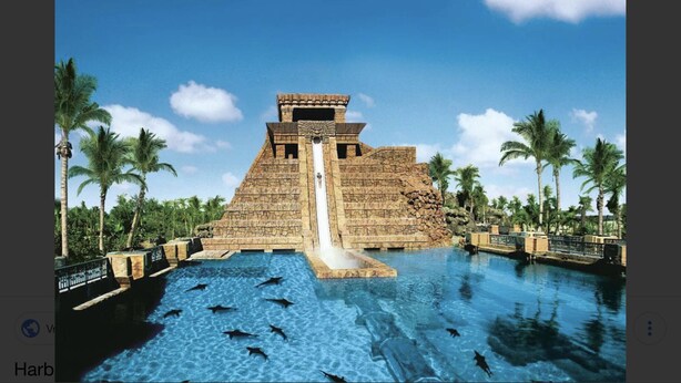 A pyramid-shaped water slide structure with a pool in front. - 1 Premium Villa - master bedroom, 1 bath, and full kitchen (Paradise Island)