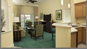 A hotel room with a living area, dining space, and kitchen. - 1 Premium Villa - master bedroom, 1 bath, and full kitchen (Paradise Island)