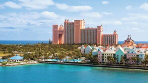 A large resort with multiple buildings, a pool area, and a view of the ocean. - 1 Premium Villa - master bedroom, 1 bath, and full kitchen (Paradise Island)