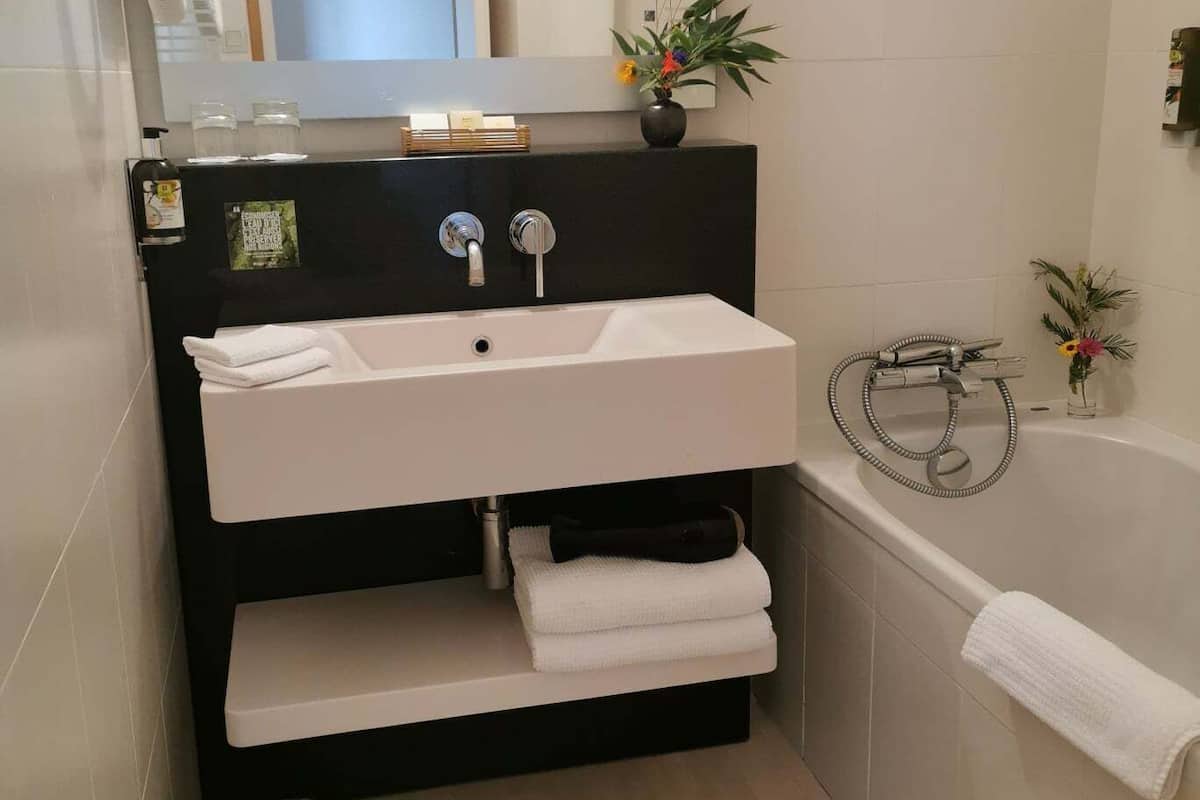 superior double room | bathroom | hair dryer, towels, soap, shampoo