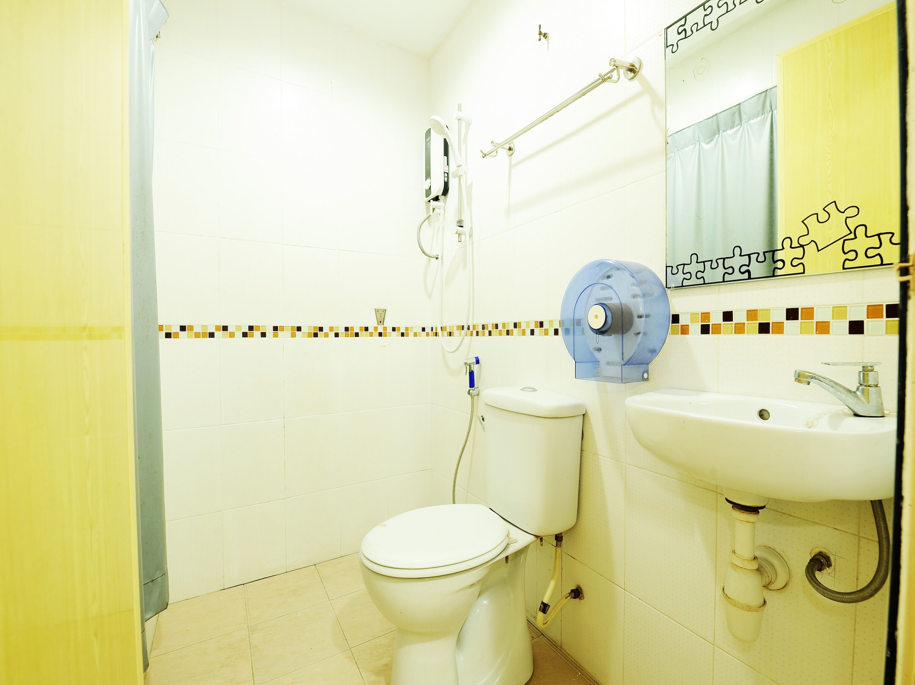 A bathroom with a toilet, sink, and shower.