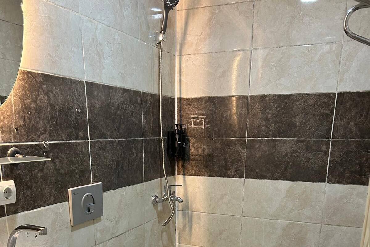 A bathroom with a sink, toilet, and shower.