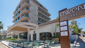 A hotel with a modern design, outdoor seating area, and multiple dining options. - Awen Lara Hotel (Antalya)