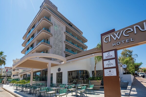 A hotel with a modern design, outdoor seating area, and multiple dining options. - Awen Lara Hotel (Antalya)